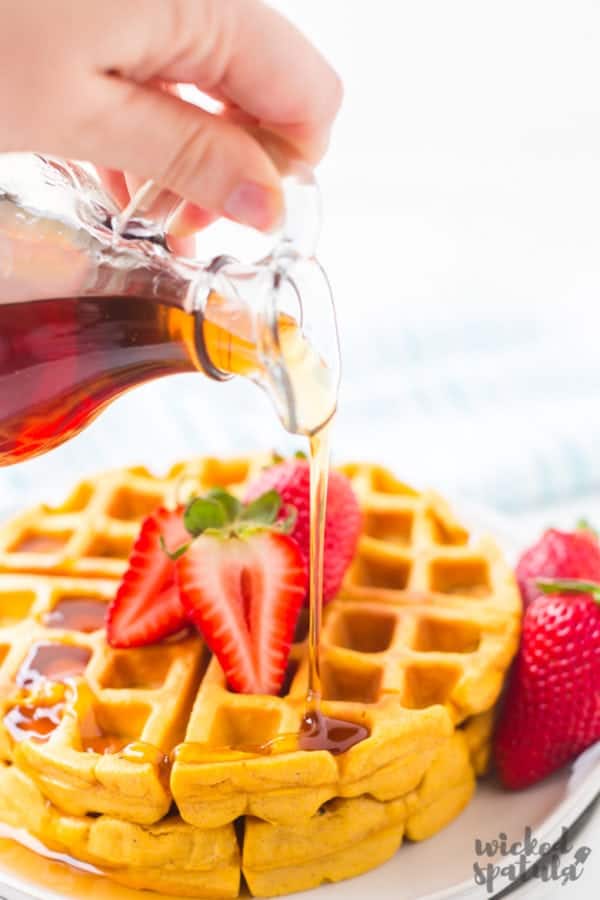 syrup being poured over paleo waffles