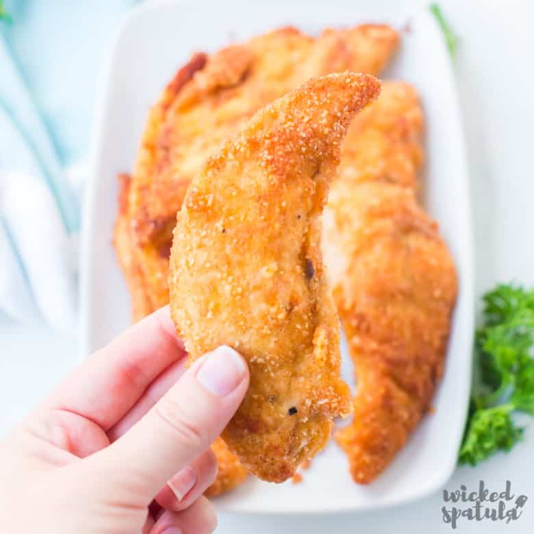 paleo fried chicken tender in hand