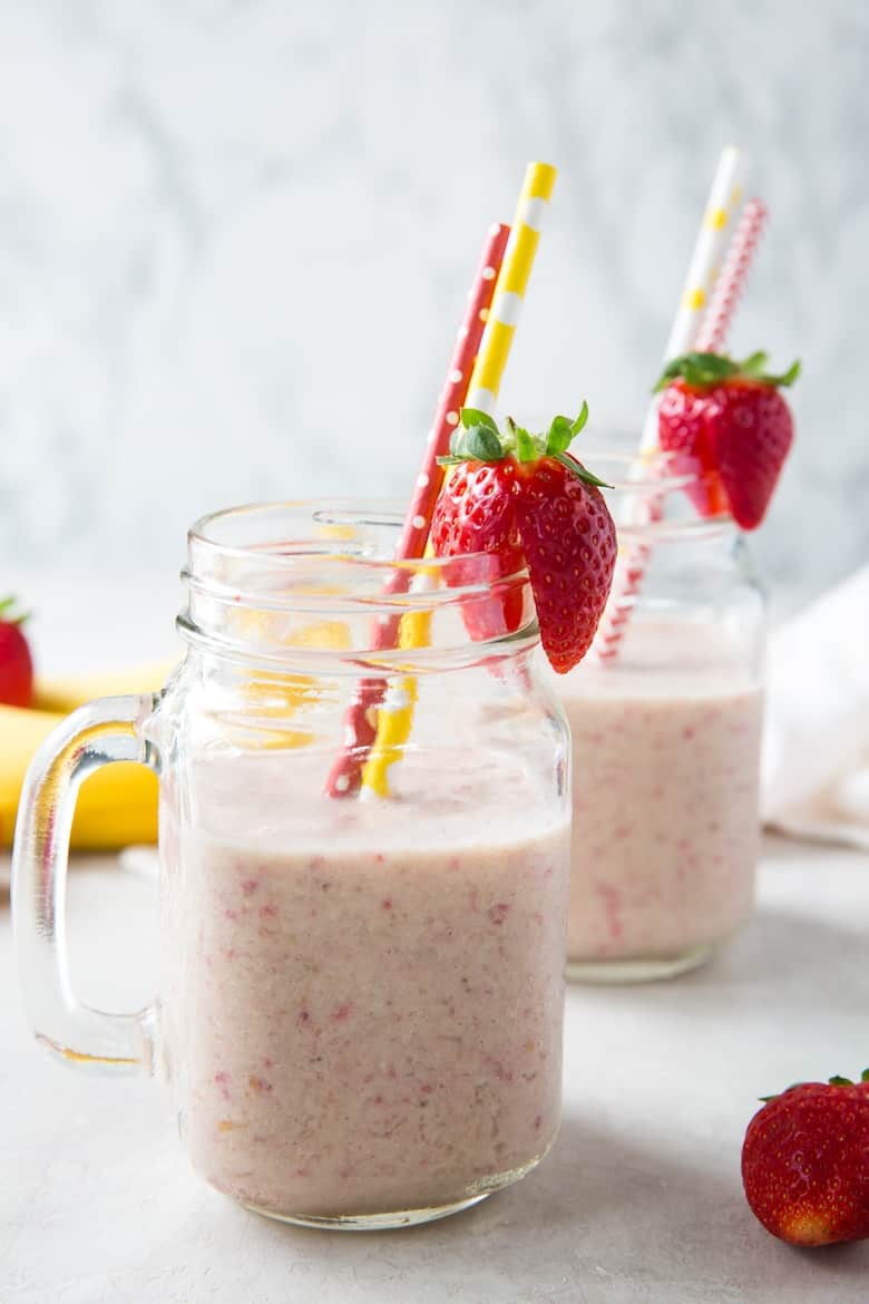 best strawberry banana smoothie recipe in two mugs with straws