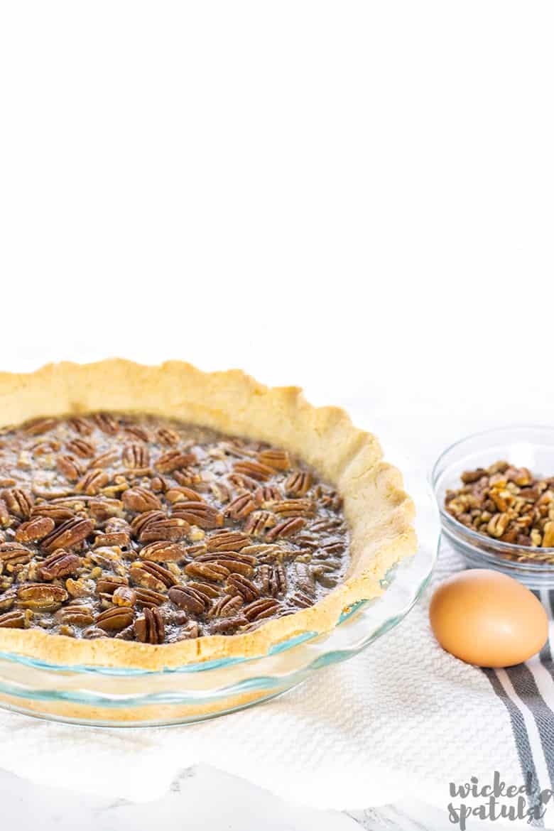 pie with an egg and bowl of pecans