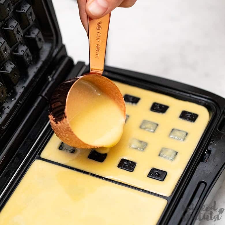 pouring paleo waffle recipe into waffle maker