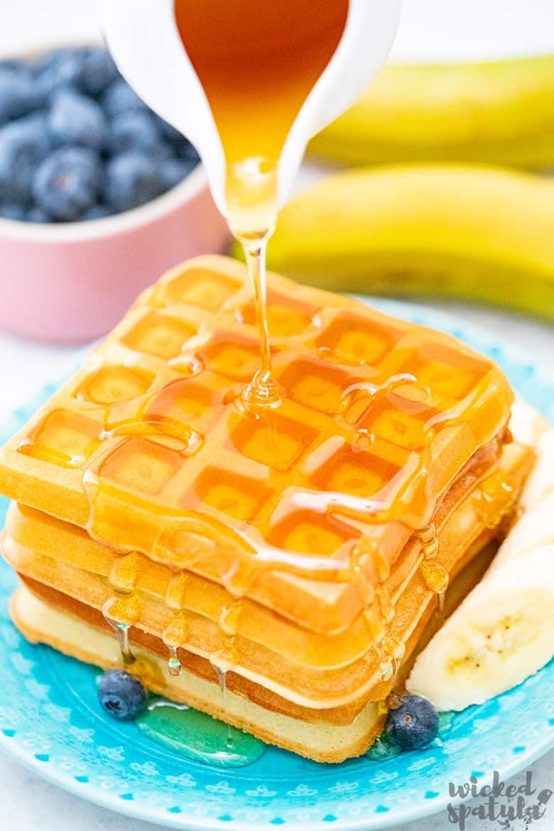 syrup pouring over almond flour waffles