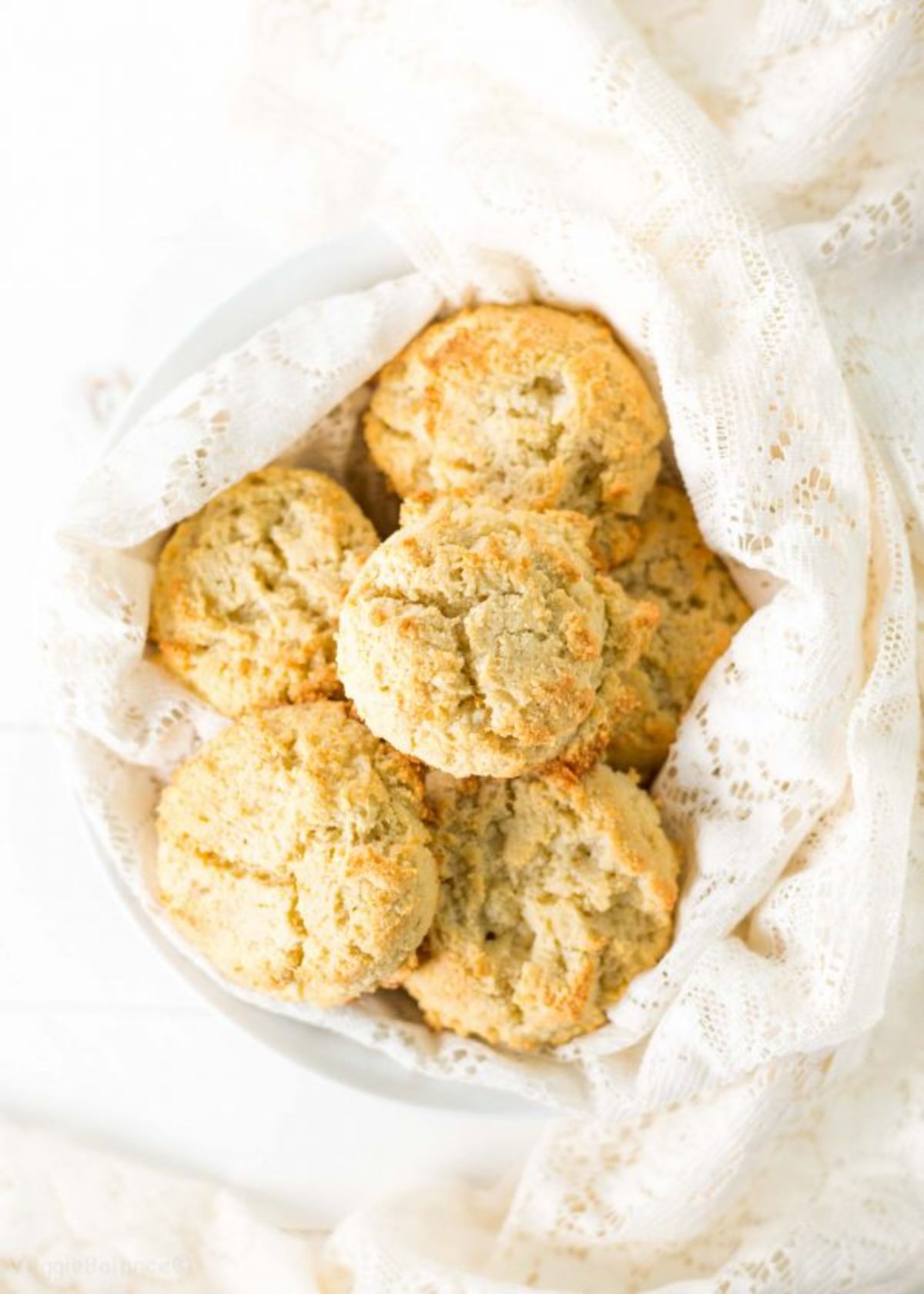 a cloth-covered basket containing a pile of biscuits