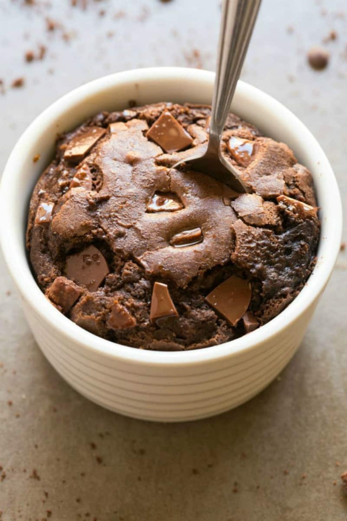 A pot filled with chocolate brownie and a spoon sticking out of it