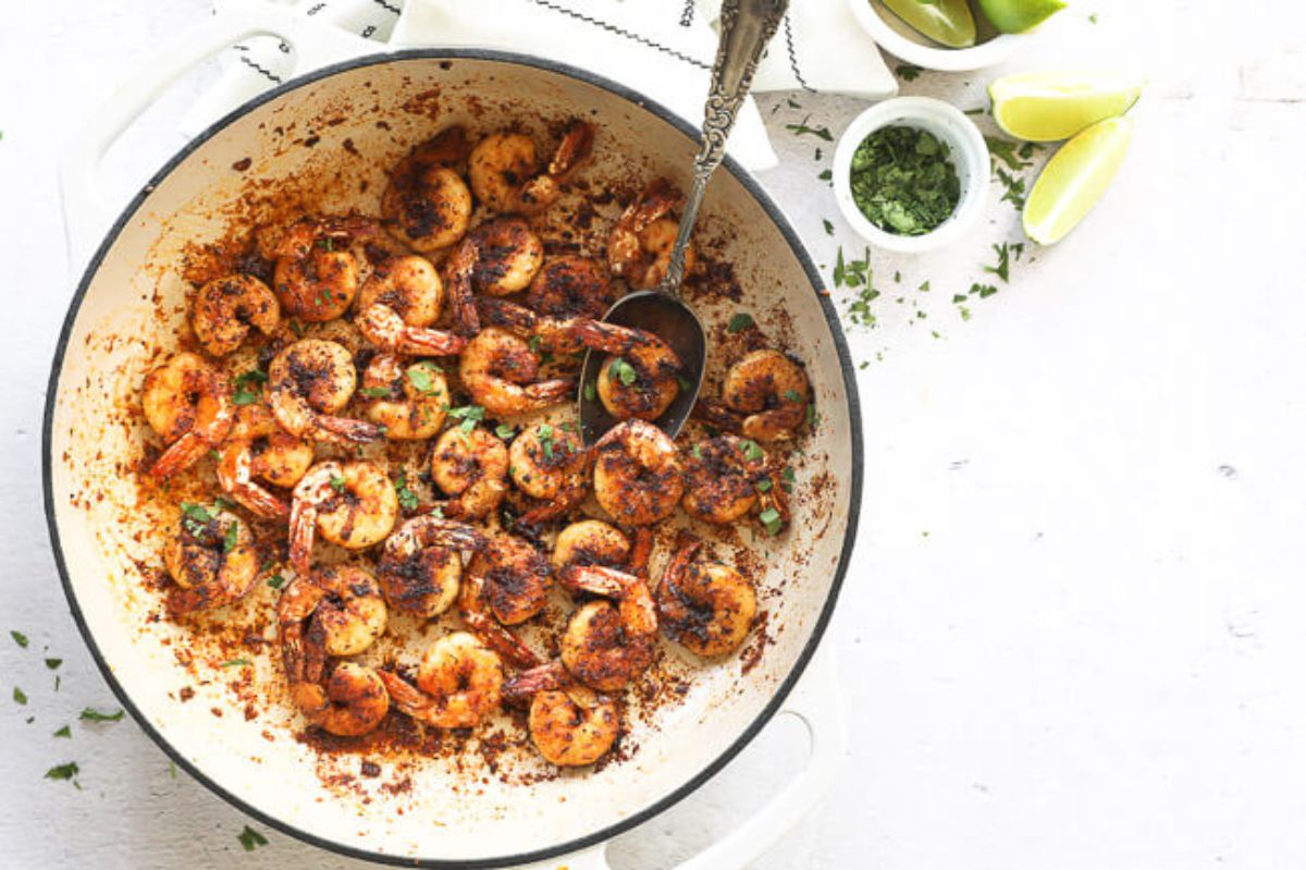 A large bowl of blackened shrimp mixed with herbs and spices