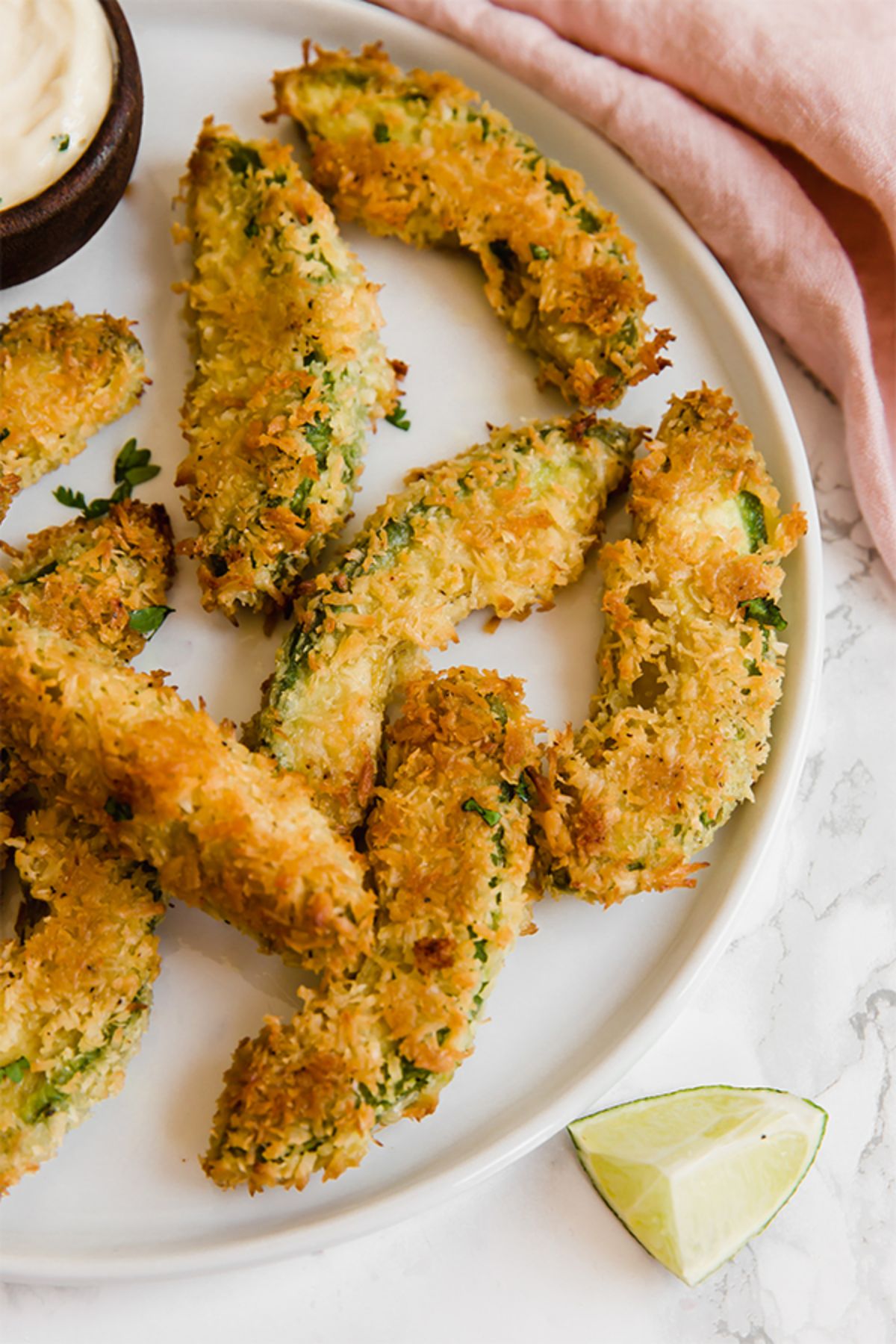 A white plate of avocado fries