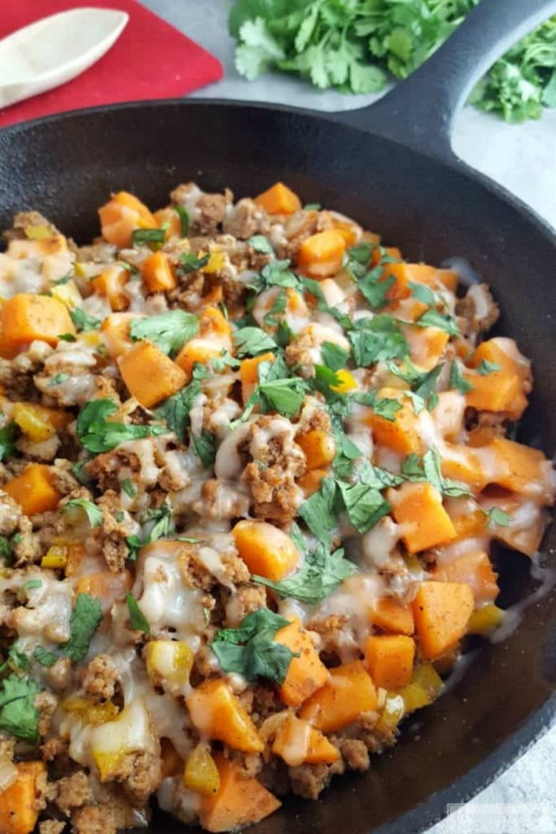 Cast iron skillet filled with ground turkey and sweet potatoes