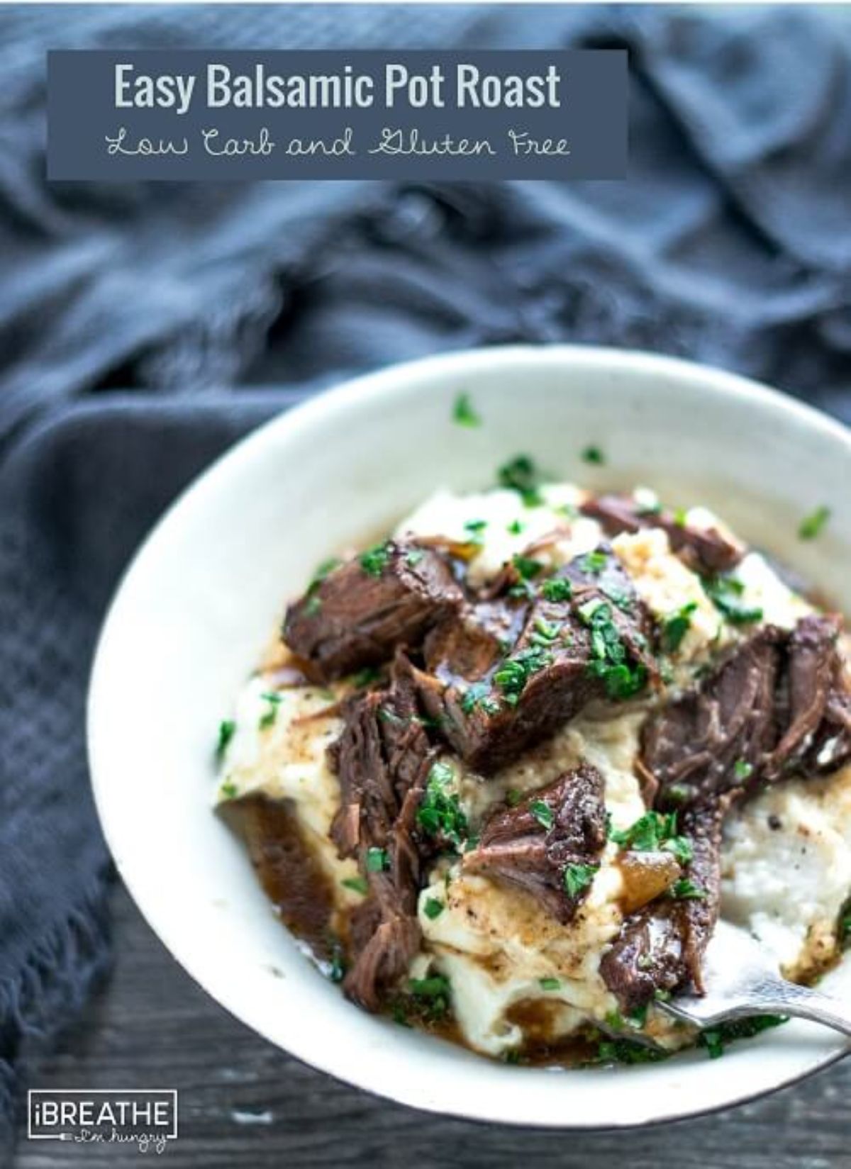 The text reads "Easy Balsami Pot Roast. Low Carb and Gluten free" On a dark gray cloth is a white bowl filled with beef stew, with soured cream and chopped herbs on top.