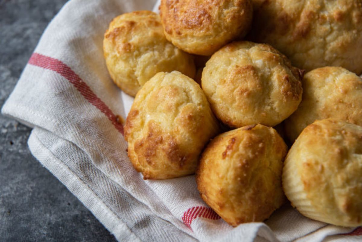 In a cloth lined basket are 8 biscuits