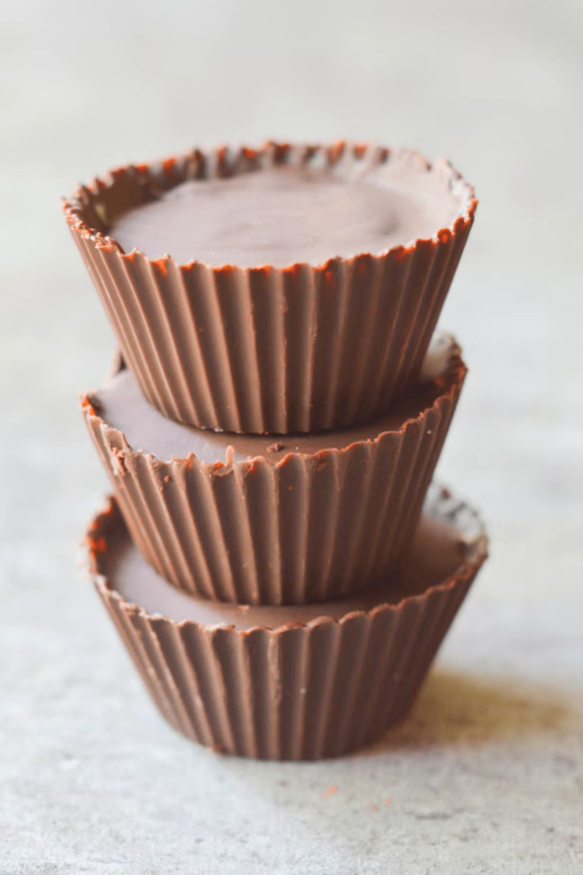 A stack of 3 chocolate cupcake shaped cheesecake bites