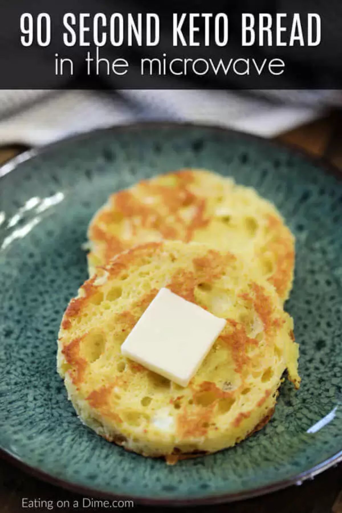 The text reads "90 second keto bread in the microwave". On a speckled green plate are two round slices of bread with a square of butter in the middle of it